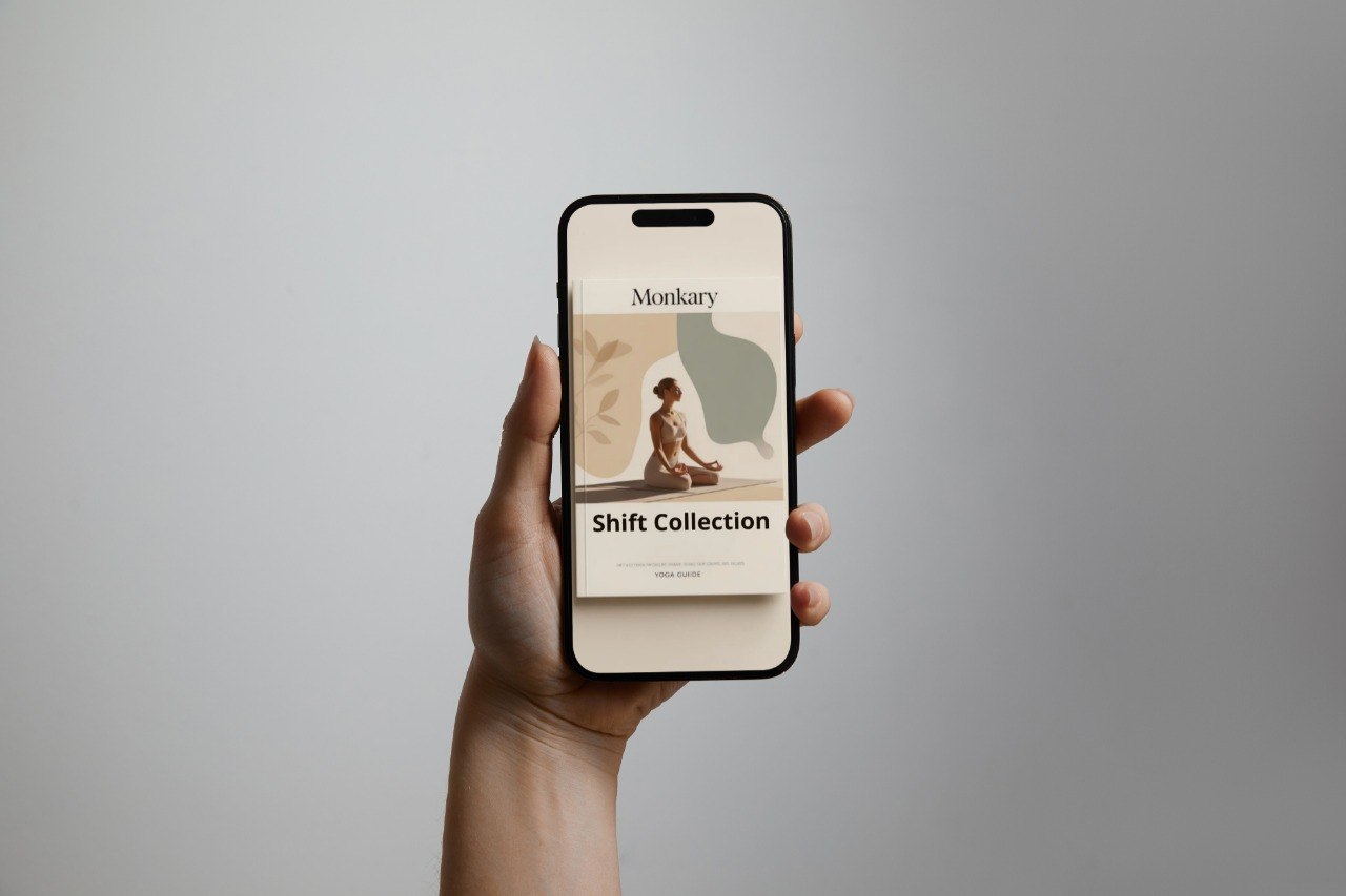 Hand holding a smartphone displaying a website with a minimalistic design on a gray background